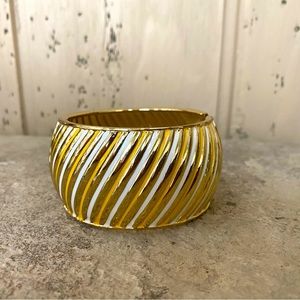 Gold, yellow and white coloured metal hinged bangle style bracelet
